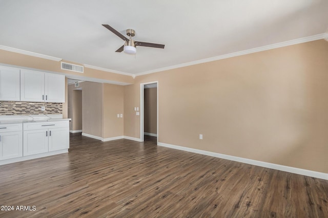 unfurnished living room with crown molding, dark wood-type flooring, and ceiling fan