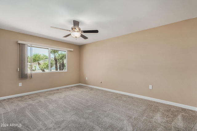 spare room featuring ceiling fan and carpet