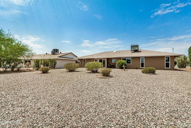 rear view of house with central AC unit