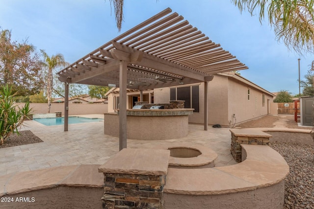 view of patio with a pergola, exterior kitchen, and a fenced in pool