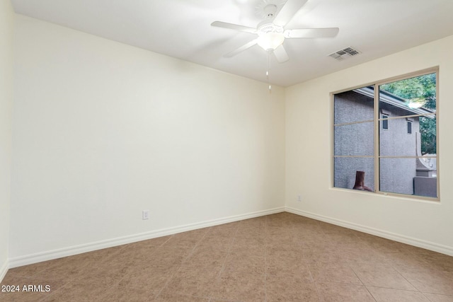 unfurnished room featuring ceiling fan and light tile patterned floors