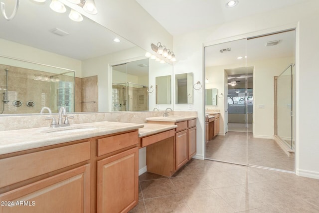 bathroom with tile patterned floors, vanity, and an enclosed shower