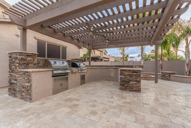 view of patio featuring an outdoor kitchen, a pergola, and grilling area