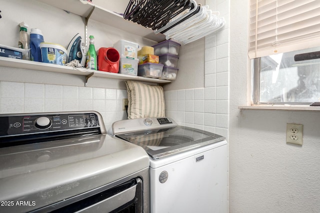 clothes washing area with washer and dryer