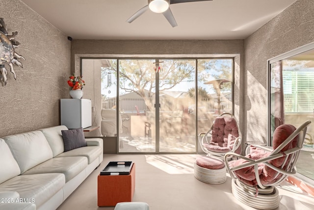 sunroom featuring ceiling fan and a healthy amount of sunlight