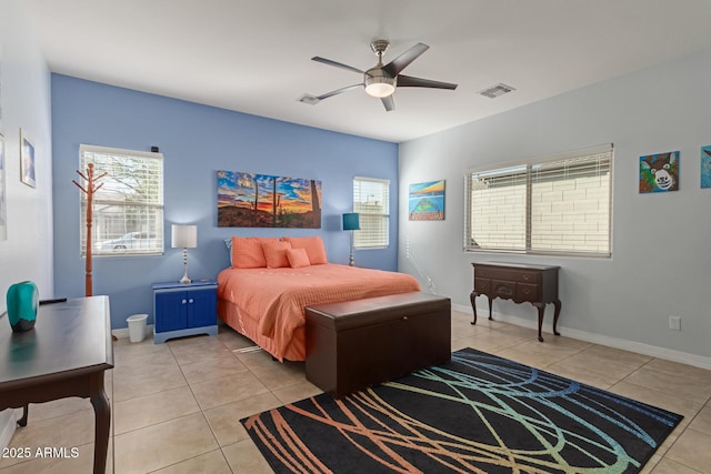 tiled bedroom featuring ceiling fan and multiple windows