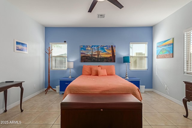 bedroom featuring ceiling fan, multiple windows, and light tile patterned floors