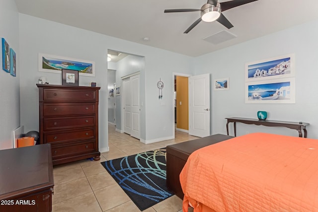 bedroom featuring a closet, ceiling fan, and light tile patterned floors