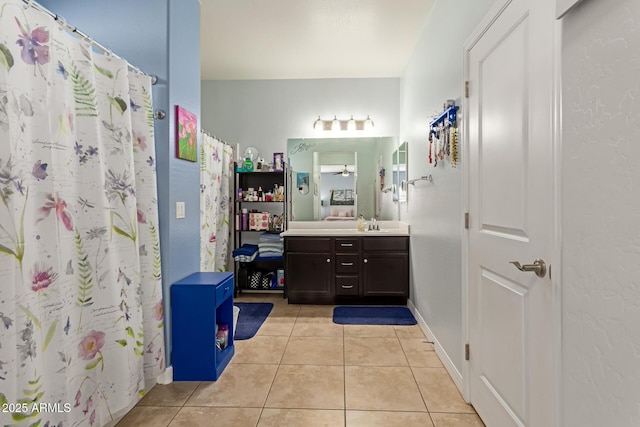 bathroom featuring ceiling fan, walk in shower, tile patterned flooring, and vanity