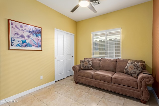 tiled living room featuring ceiling fan