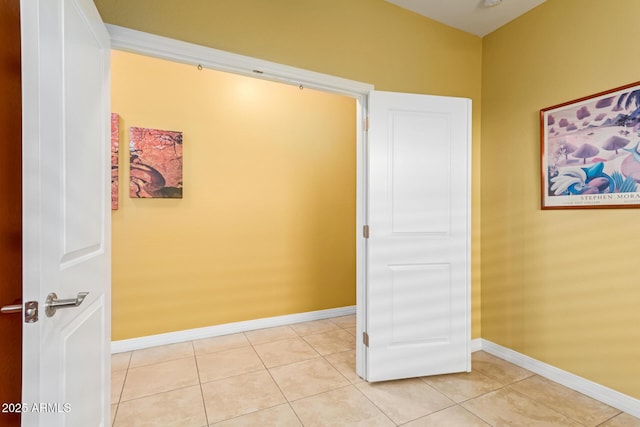 hall featuring light tile patterned flooring