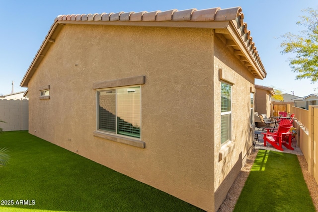 view of side of home with a lawn