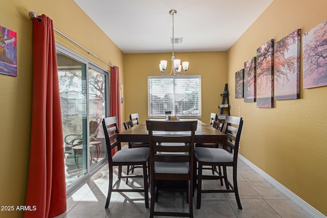 dining space featuring a notable chandelier, light tile patterned flooring, and a wealth of natural light