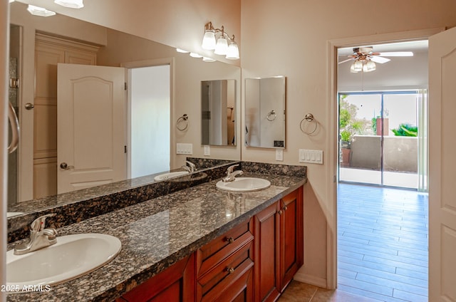 bathroom featuring double vanity, a ceiling fan, and a sink