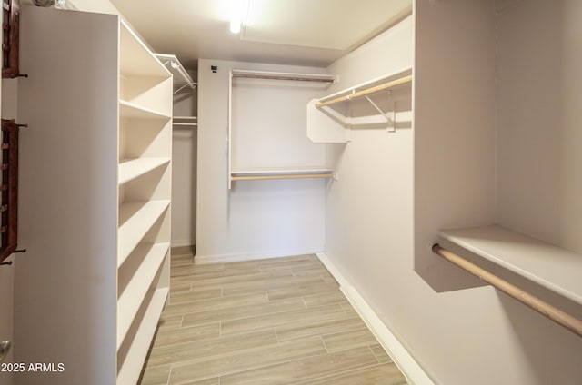 spacious closet with wood tiled floor