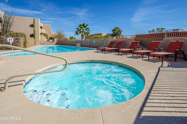 pool with fence and a patio