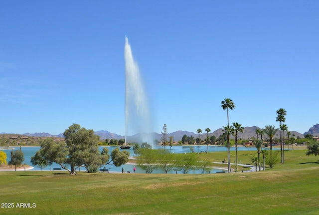 view of home's community with a yard and a water and mountain view