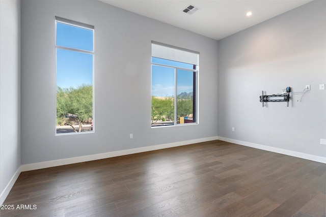 spare room featuring dark hardwood / wood-style floors