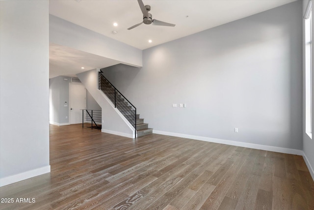 unfurnished living room featuring ceiling fan and hardwood / wood-style floors