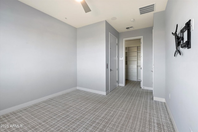 unfurnished room featuring light colored carpet and ceiling fan