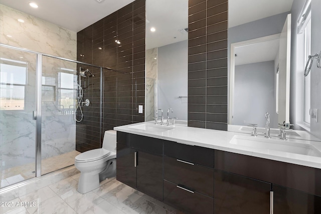 bathroom with a shower with door, vanity, and toilet