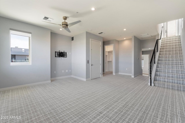 unfurnished living room with ceiling fan and light colored carpet