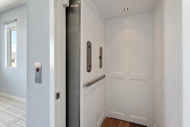 room details with elevator and wood-type flooring