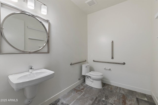 bathroom featuring toilet and sink