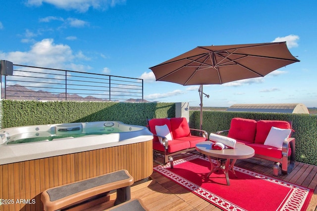 wooden deck with a hot tub and an outdoor hangout area