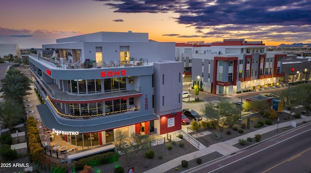 view of outdoor building at dusk