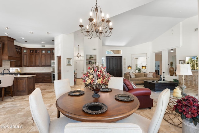7734 E Monica Dr, Scottsdale, AZ 85255 - dining area featuring a chandelier and a towering ceiling