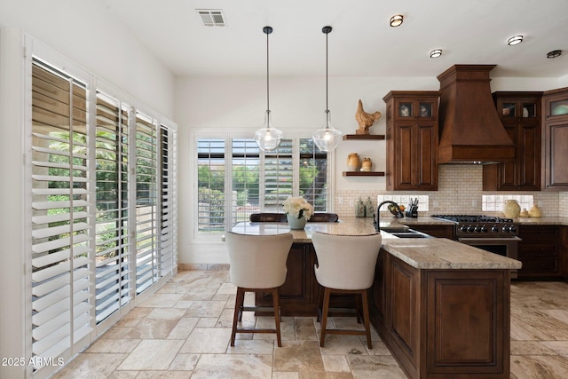 7734 E Monica Dr, Scottsdale, AZ 85255 - kitchen with high end range, custom exhaust hood, stone tile floors, open shelves, and a sink