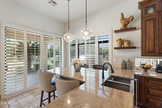 7734 E Monica Dr, Scottsdale, AZ 85255 - kitchen with open shelves, plenty of natural light, a sink, and light stone countertops