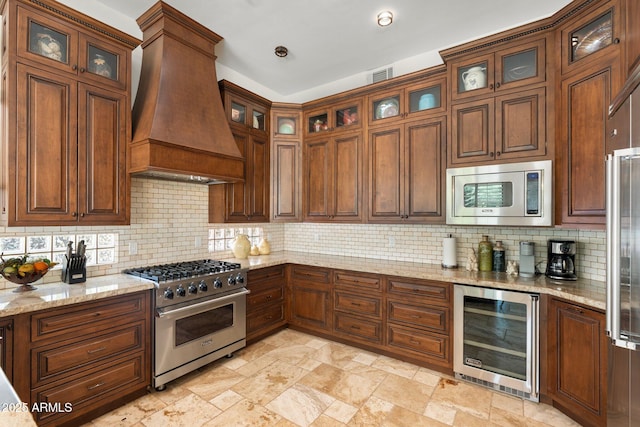 7734 E Monica Dr, Scottsdale, AZ 85255 - kitchen featuring high quality appliances, beverage cooler, premium range hood, decorative backsplash, and light stone countertops
