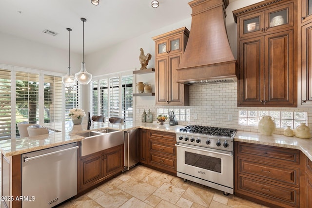7734 E Monica Dr, Scottsdale, AZ 85255 - kitchen featuring stainless steel appliances, custom range hood, a peninsula, decorative backsplash, and brown cabinets
