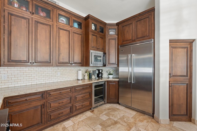 7734 E Monica Dr, Scottsdale, AZ 85255 - kitchen with built in appliances, wine cooler, decorative backsplash, light stone finish floors, and light stone counters