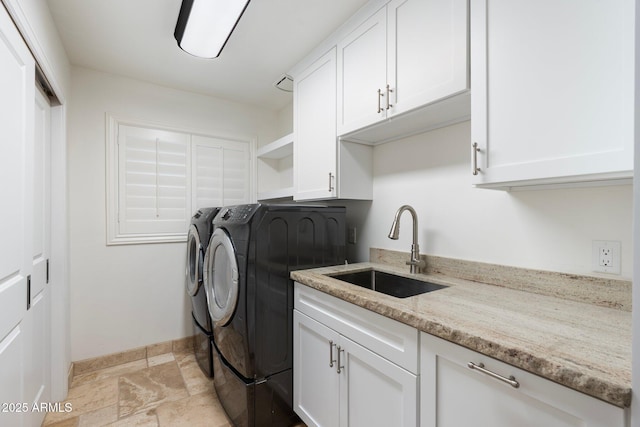 7734 E Monica Dr, Scottsdale, AZ 85255 - laundry room featuring washer and clothes dryer, baseboards, stone tile flooring, and cabinet space