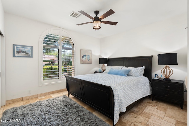 7734 E Monica Dr, Scottsdale, AZ 85255 - bedroom featuring light stone finish floors, a ceiling fan, and baseboards