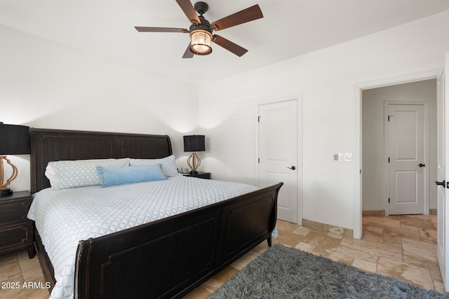 7734 E Monica Dr, Scottsdale, AZ 85255 - bedroom featuring light stone finish flooring, ceiling fan, and baseboards