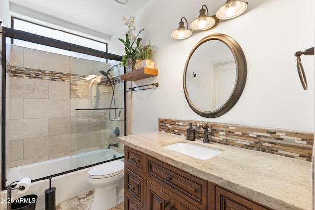 7734 E Monica Dr, Scottsdale, AZ 85255 - full bathroom with decorative backsplash, vanity, toilet, and shower / bath combination with glass door