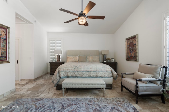 7734 E Monica Dr, Scottsdale, AZ 85255 - bedroom featuring stone tile flooring, lofted ceiling, baseboards, and ceiling fan