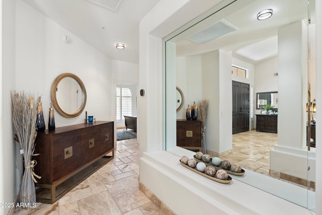 7734 E Monica Dr, Scottsdale, AZ 85255 - hallway with stone tile floors and high vaulted ceiling