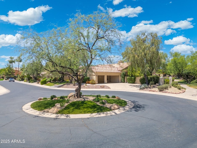 7734 E Monica Dr, Scottsdale, AZ 85255 - view of front facade featuring an attached garage, curved driveway, and stucco siding
