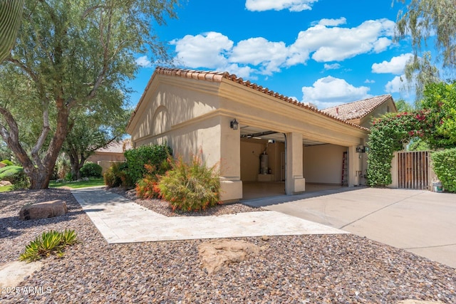 7734 E Monica Dr, Scottsdale, AZ 85255 - view of property exterior with driveway, stucco siding, a tile roof, and a garage