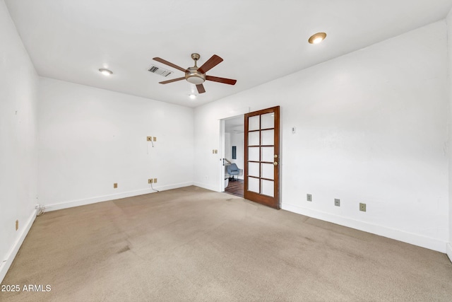 empty room with ceiling fan, baseboards, and carpet