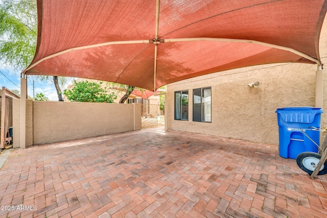 view of patio featuring fence and a gate
