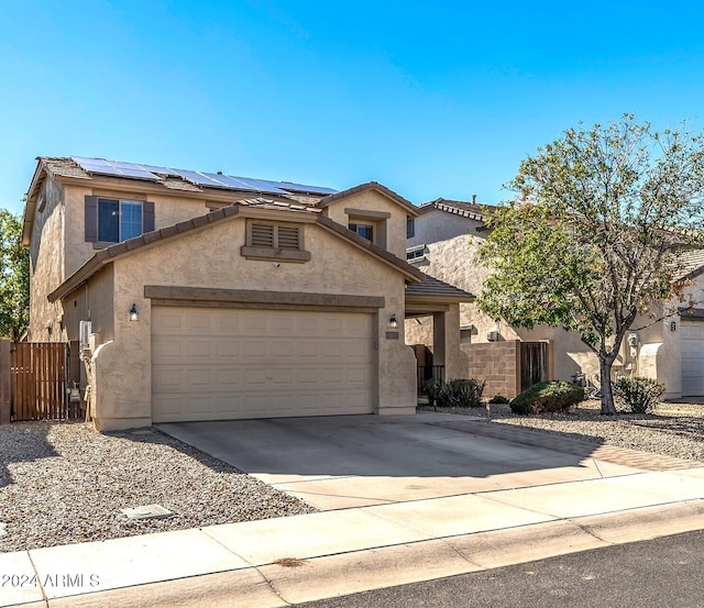 view of front of home with solar panels and a garage