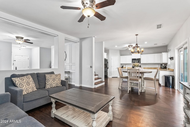 living room with a notable chandelier and dark hardwood / wood-style flooring