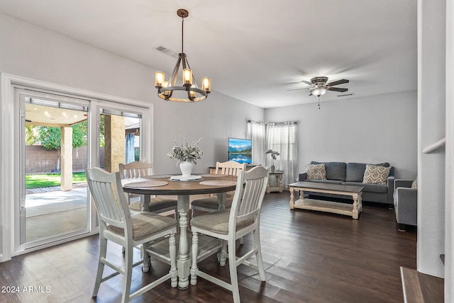 dining area with dark hardwood / wood-style floors and ceiling fan with notable chandelier