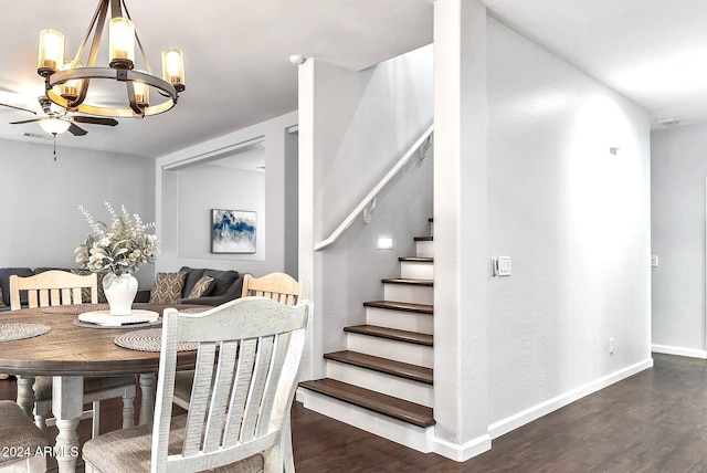 dining space featuring dark hardwood / wood-style floors and ceiling fan with notable chandelier